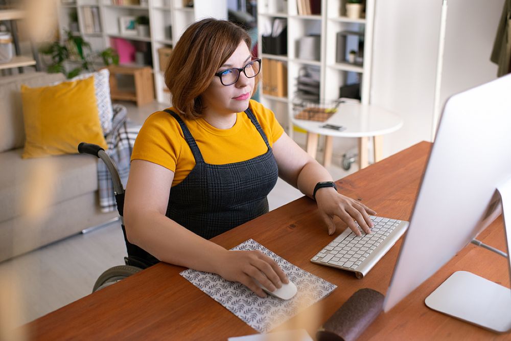 Woman business owner working from home seated in wheelchair