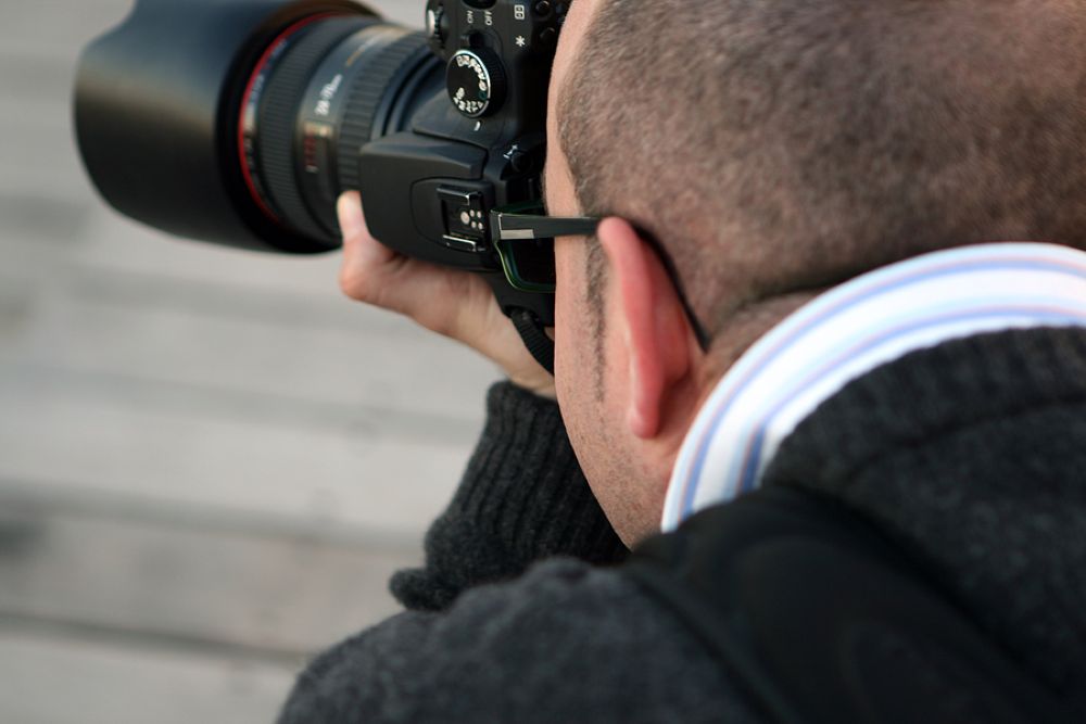 Photographer taking a photo with a long lens