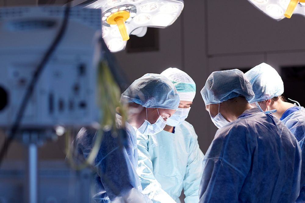 Group of surgeons in scrubs in the operating room