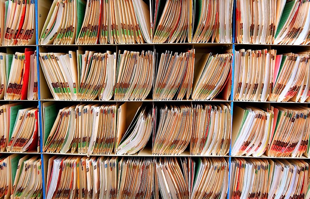 Medical records paper files on a wall filing system disability notes